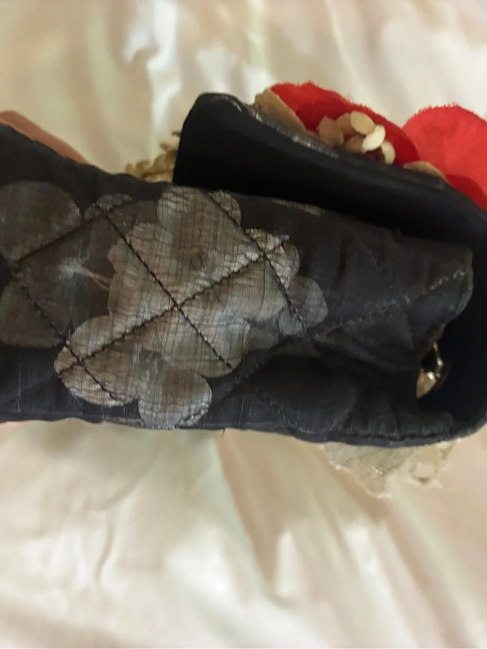 CHANEL Black Quilted Shoulder Bag with Red Floral Appliqués